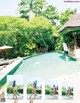 A woman in a bikini standing next to a swimming pool.